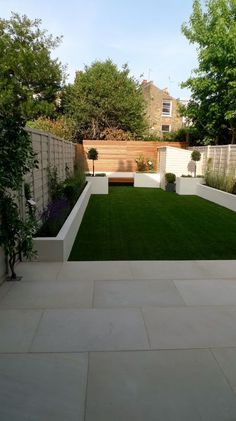Plain Gated Backyard With White Plant Beds
